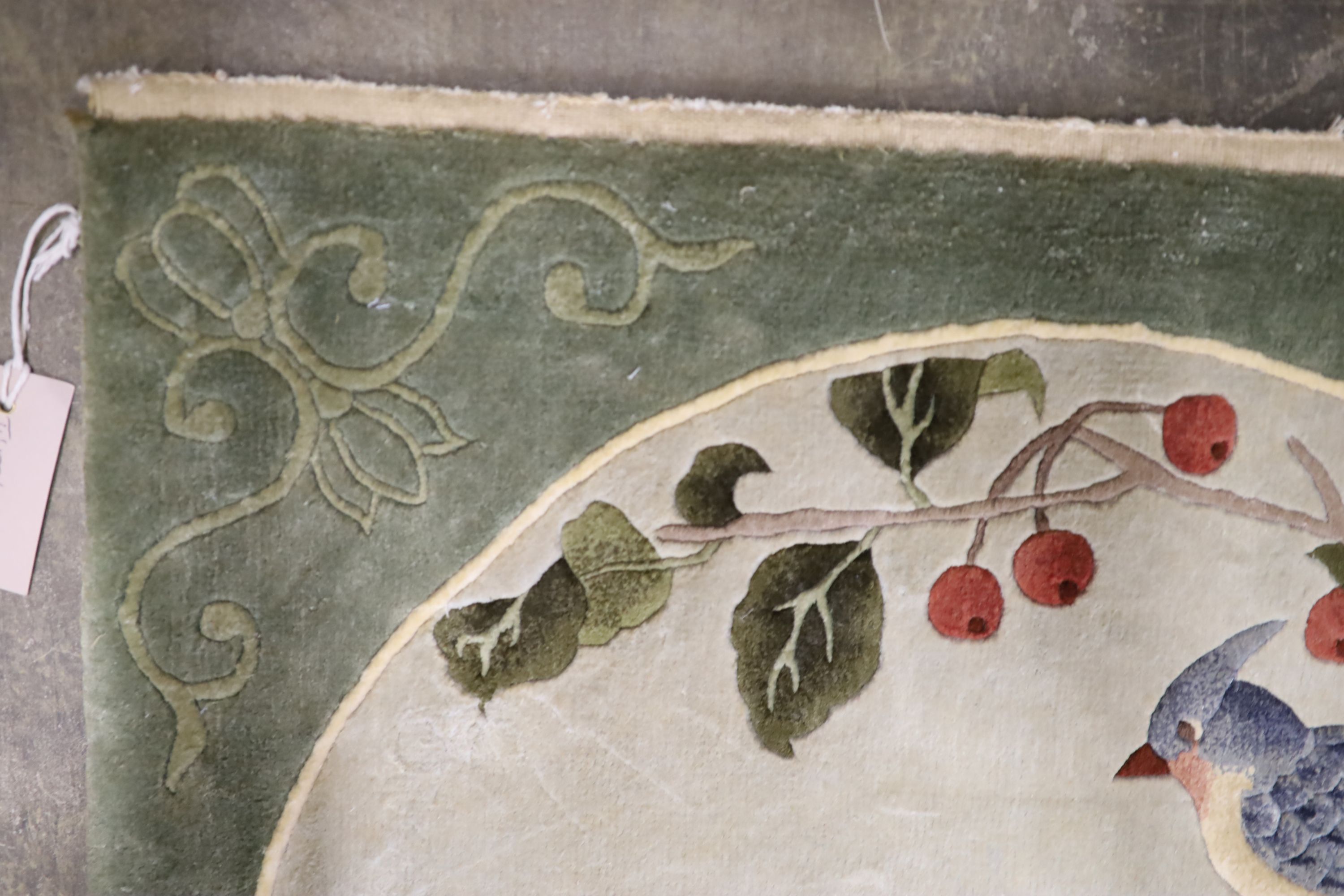 A Chinese washed and embossed panel depicting birds amongst prunus and cherries